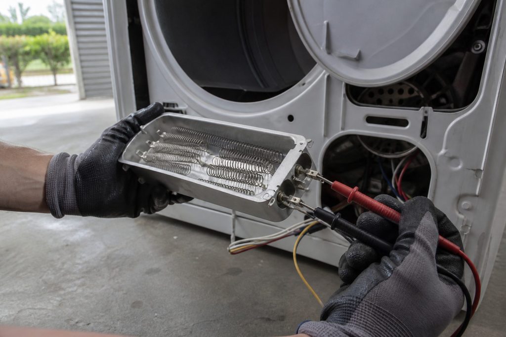 A dryer heating element and its housing out of the cabinet.